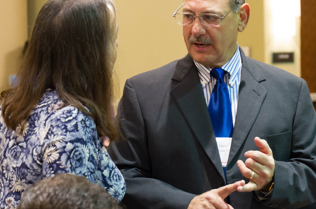 Dr. Mark Mandel and Linda Elsegood making final preparations for the conference